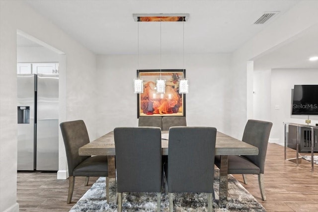 dining area with wood-type flooring