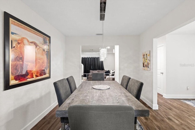 dining space with dark hardwood / wood-style flooring