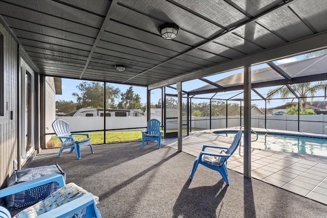 sunroom / solarium featuring a wealth of natural light and a pool