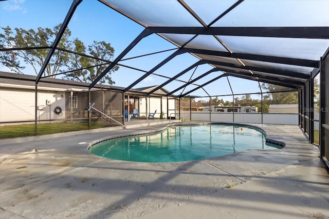 view of swimming pool with a lanai and a patio area