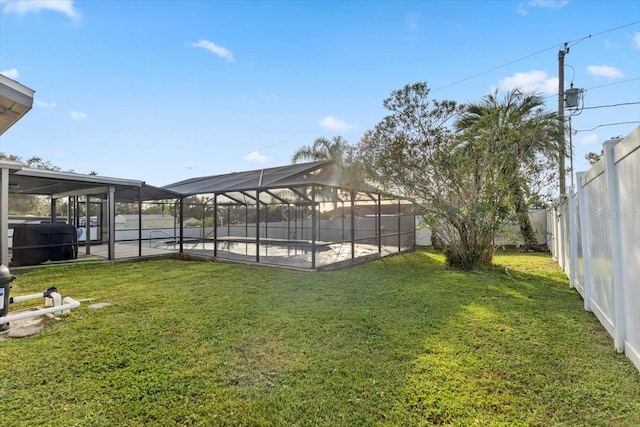 view of yard with a swimming pool, a patio, and a lanai