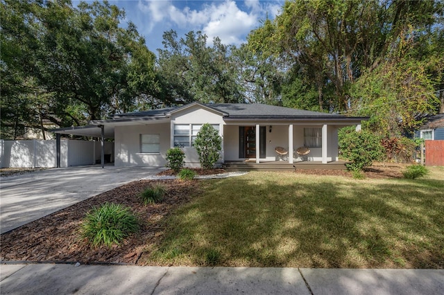 ranch-style home with a front yard, a carport, and a porch