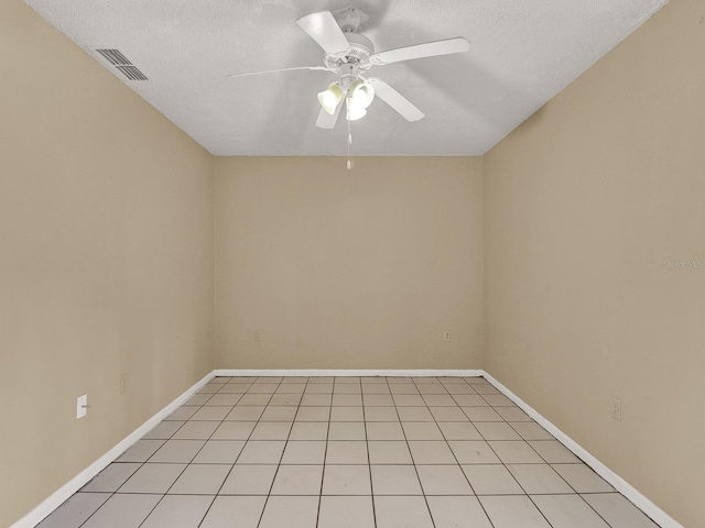 tiled empty room with a textured ceiling and ceiling fan