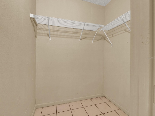 spacious closet with light tile patterned floors