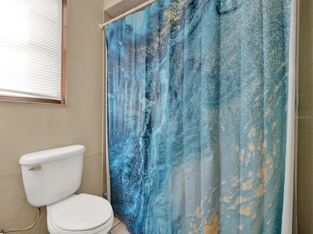 bathroom with tile patterned flooring and toilet