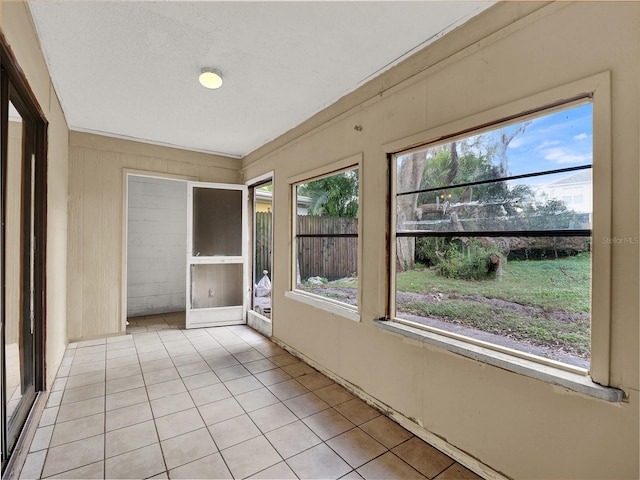 unfurnished sunroom featuring a wealth of natural light