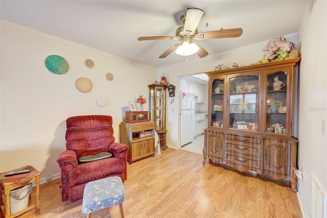 living area featuring ceiling fan and light hardwood / wood-style floors