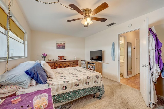 bedroom with ceiling fan and light carpet