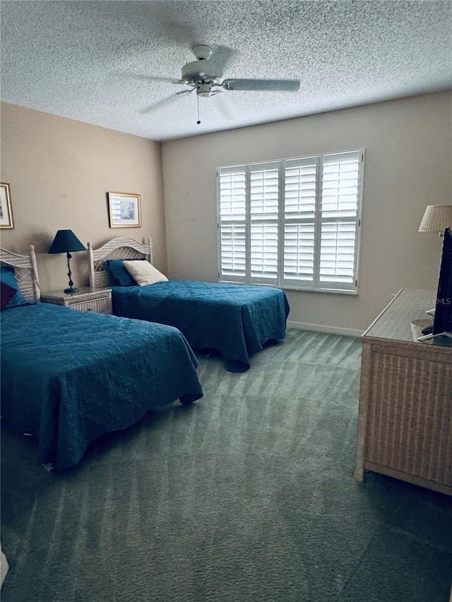 carpeted bedroom featuring ceiling fan and a textured ceiling