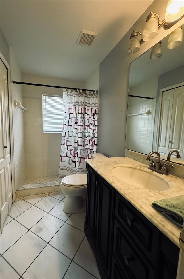 bathroom featuring tile patterned floors, a shower with curtain, vanity, and toilet