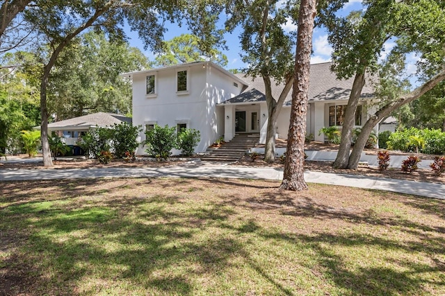 view of front facade featuring french doors and a front lawn