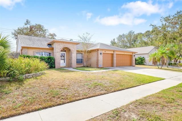 single story home featuring a garage and a front lawn