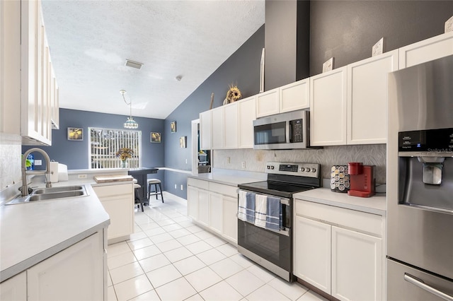 kitchen with pendant lighting, stainless steel appliances, white cabinetry, and sink