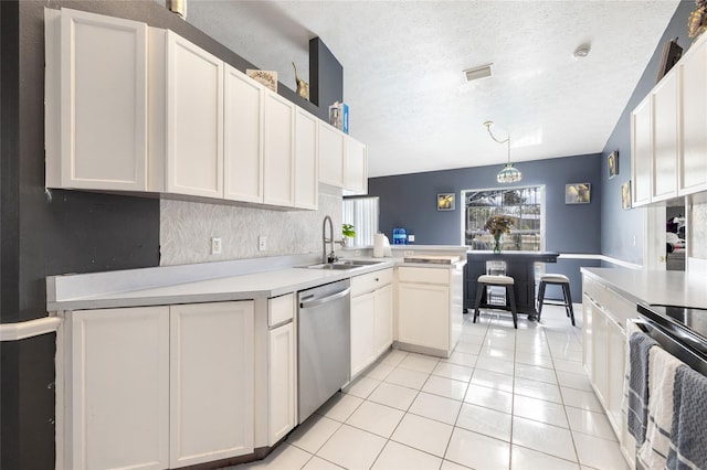 kitchen with stainless steel appliances, a textured ceiling, decorative light fixtures, sink, and white cabinets