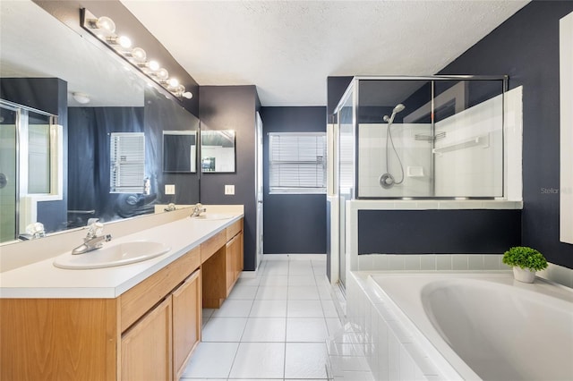 bathroom with separate shower and tub, vanity, a textured ceiling, and tile patterned floors