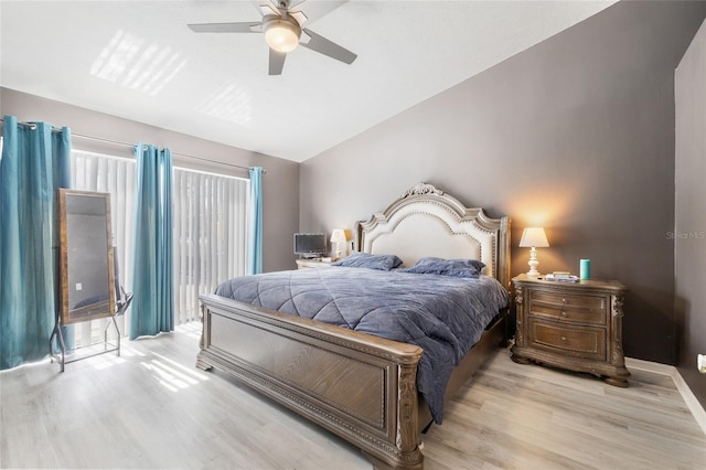 bedroom featuring light wood-type flooring, multiple windows, and ceiling fan