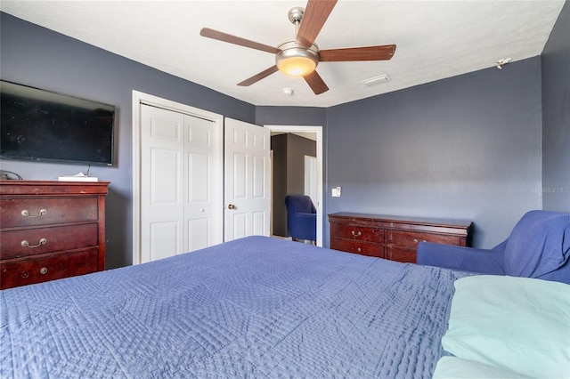 bedroom with ceiling fan and a closet