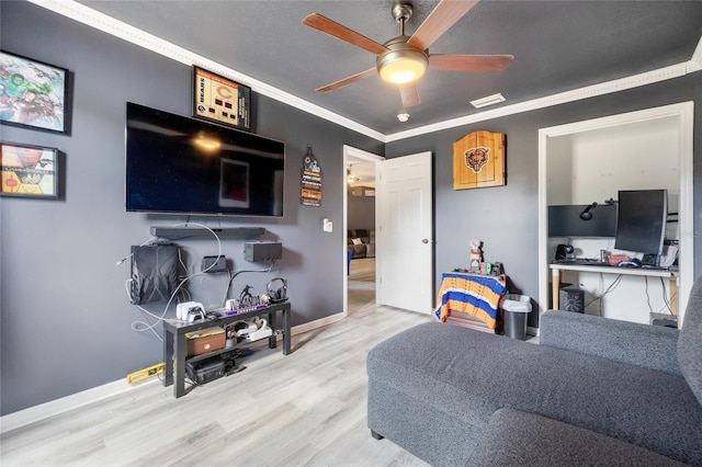 living room with ornamental molding, ceiling fan, and light hardwood / wood-style flooring