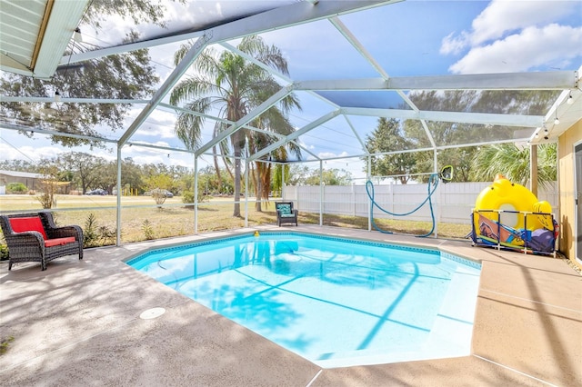 view of swimming pool with a lanai and a patio