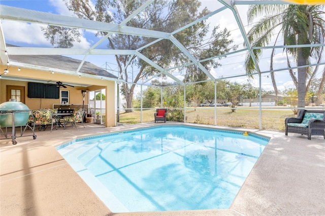 view of pool with a lanai, ceiling fan, and a patio