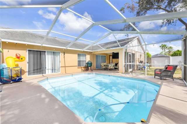 view of pool with a patio, a lanai, and ceiling fan