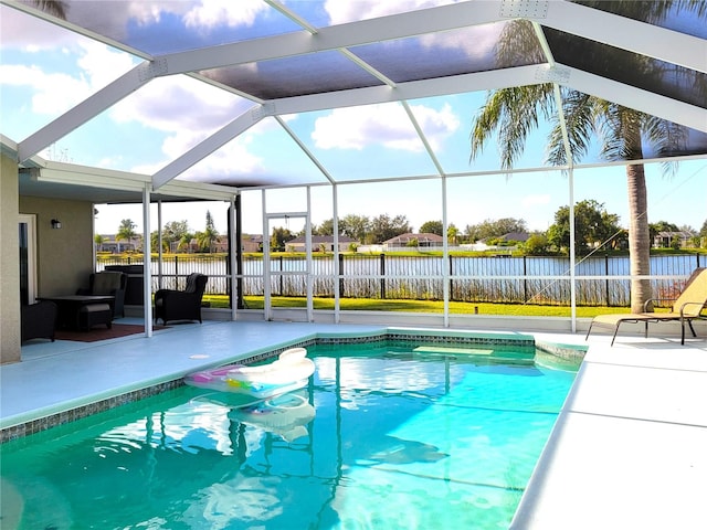 view of pool with an outdoor hangout area, glass enclosure, and a patio area