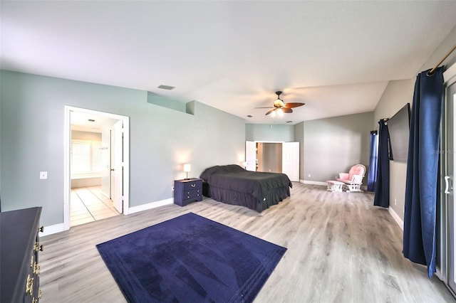 bedroom with ceiling fan, light hardwood / wood-style floors, and ensuite bath