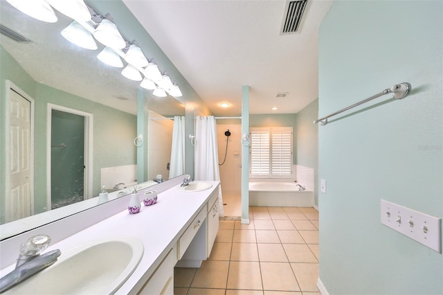 bathroom featuring tile patterned flooring, vanity, and shower with separate bathtub