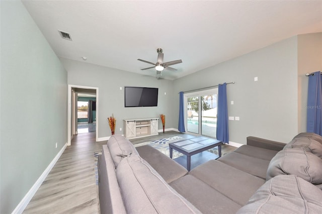 living room with ceiling fan and light hardwood / wood-style flooring