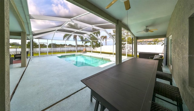 view of pool featuring a lanai, a patio area, and ceiling fan