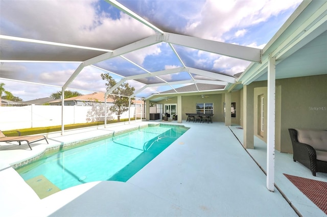 view of pool with a patio, ceiling fan, and a lanai