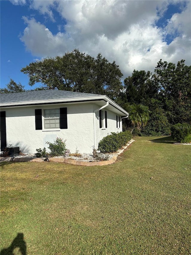 view of property exterior with a lawn