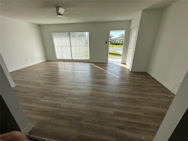 spare room featuring ceiling fan, a textured ceiling, and dark hardwood / wood-style flooring