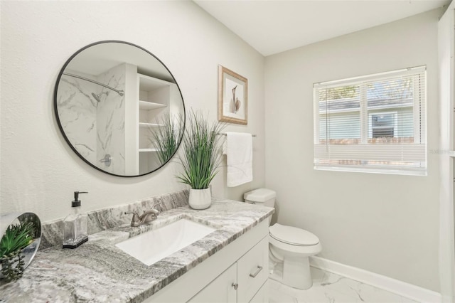 bathroom featuring vanity, toilet, and walk in shower