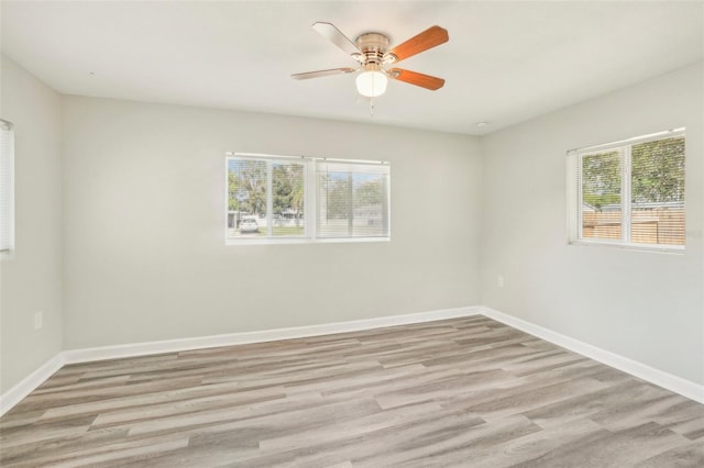 unfurnished room with light wood-type flooring, plenty of natural light, and ceiling fan