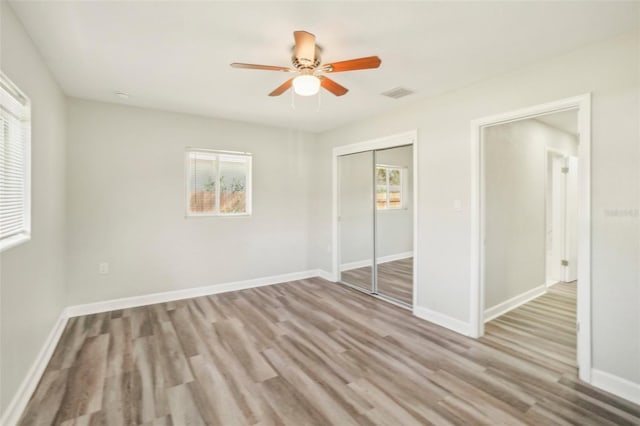 unfurnished bedroom with a closet, ceiling fan, and light hardwood / wood-style floors