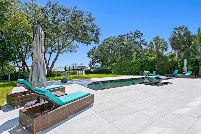 view of swimming pool featuring a patio area and an in ground hot tub