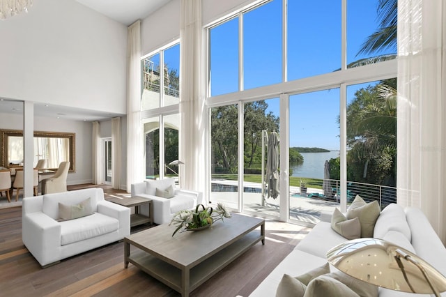 sunroom featuring a wealth of natural light and a water view