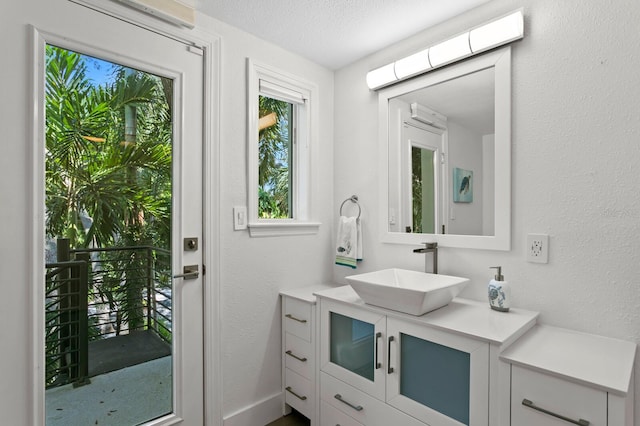 bathroom with a textured ceiling and vanity