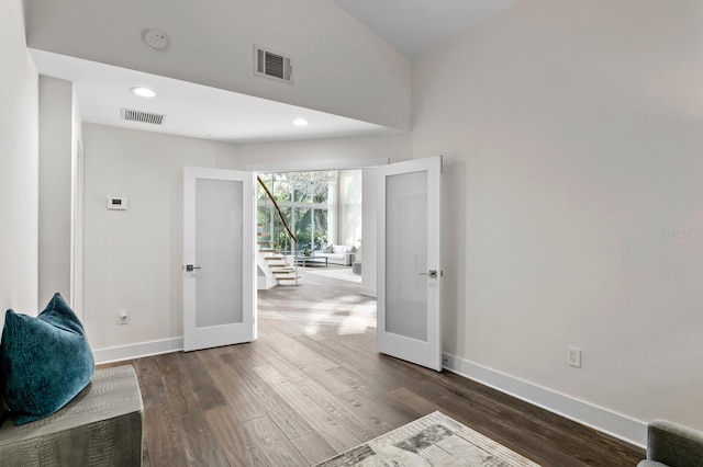 living area with french doors and dark wood-type flooring