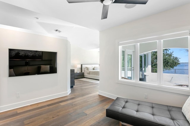 living room featuring ceiling fan, dark wood-type flooring, and vaulted ceiling