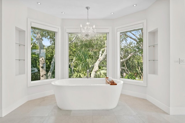 bathroom featuring a tub to relax in, tile patterned floors, and a chandelier