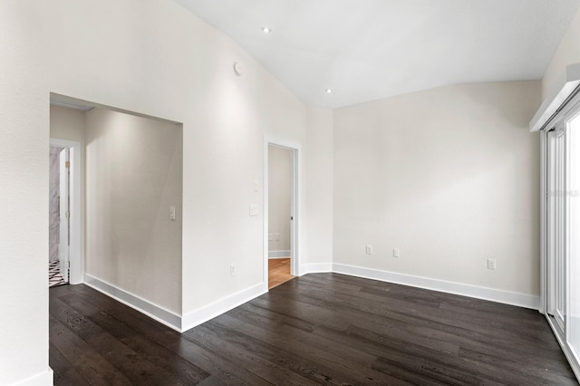 unfurnished room with dark hardwood / wood-style flooring and vaulted ceiling