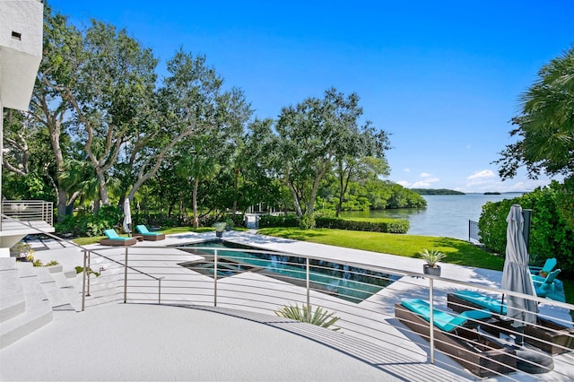 view of pool featuring a patio area, a yard, and a water view