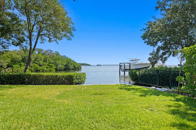 view of dock featuring a yard and a water view