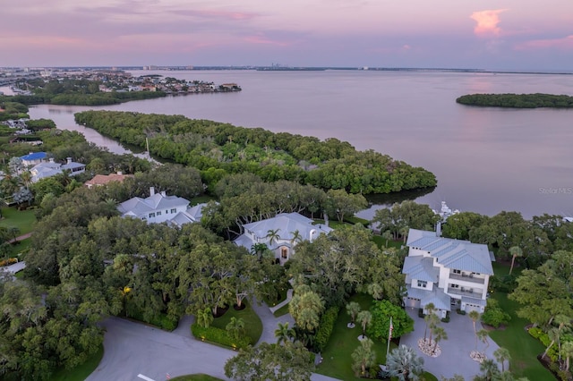 aerial view at dusk with a water view