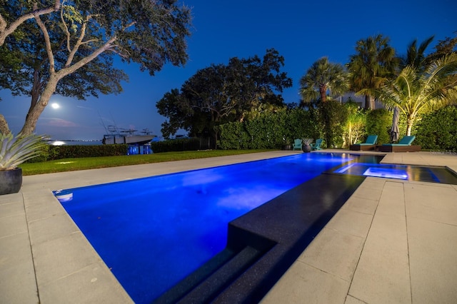 view of pool at dusk