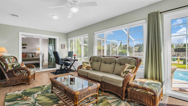 living room featuring hardwood / wood-style floors and ceiling fan