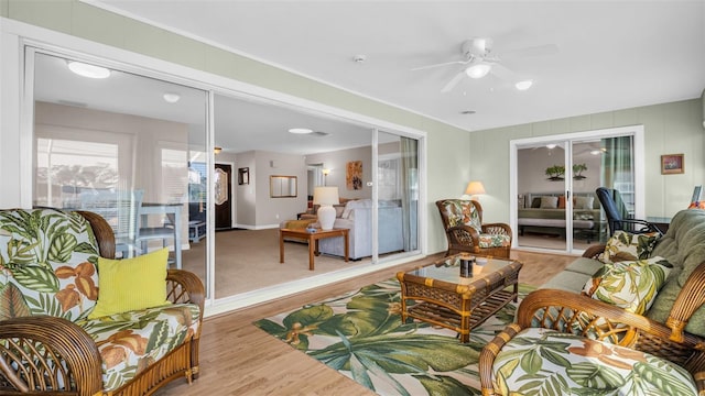 living room with ceiling fan and light hardwood / wood-style floors