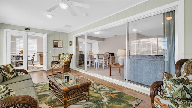 living room with wood-type flooring and ceiling fan